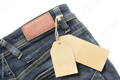 Close up of blue jeans with price tag isolated on white background.