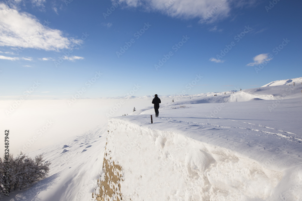 Man standing on old castle in snow