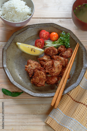 a plate of crispy chicken karaage with mayonnaise and sesame seeds