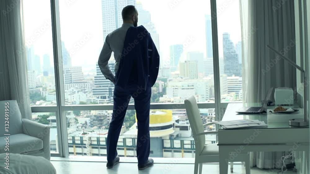 Young businessman admire view standing by window at home
Young businessman admire view standing by window at home