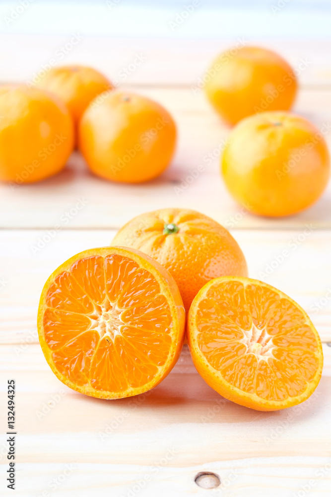 Fresh oranges cut on wooden background Fresh oranges cut on wooden background