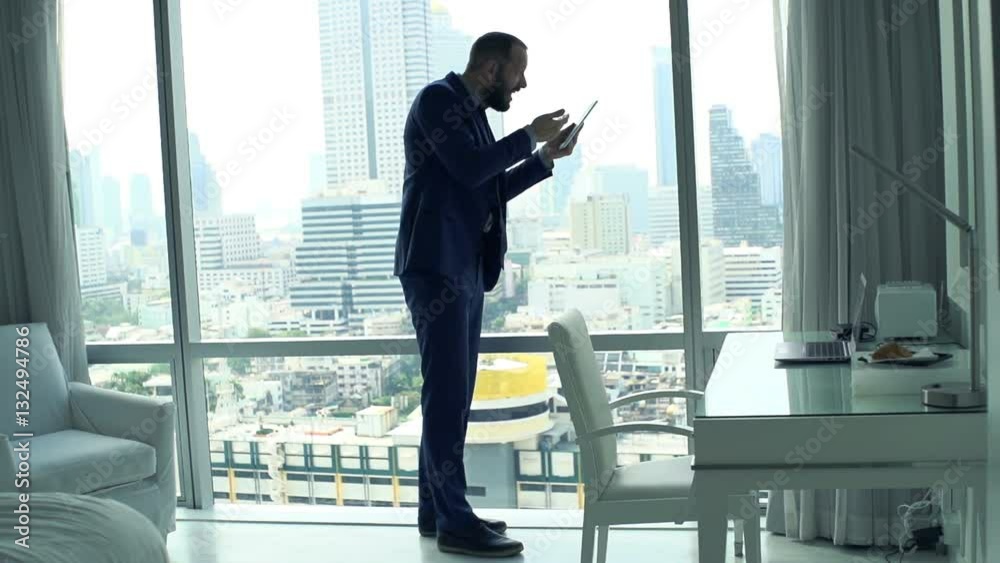 Unhappy businessman reading bad news on tablet in office, super slow motion 120fps
Unhappy businessman reading bad news on tablet in office, super slow motion 120fps