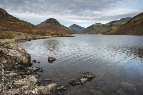 Beautiful sunset landscape image of Wast Water and mountains in photo