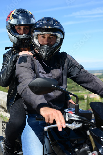 happy young biker couple riding their motorbike in summer © W PRODUCTION