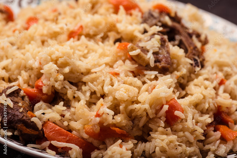 Pilaf on plate with oriental ornament. Central-Asian cuisine - Plov. Macro. Pilaf on plate with oriental ornament. Central-Asian cuisine - Plov. Macro.