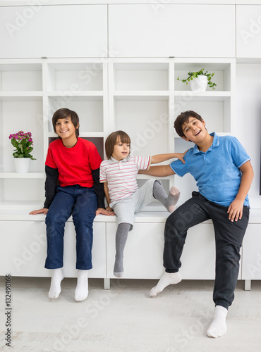 Happy children having fun and posing in new modern home