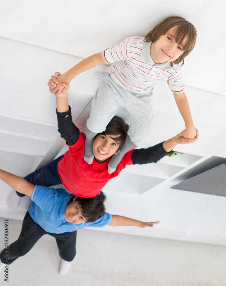 Fototapeta premium Cheerful funny children having fun and posing line up piggyback