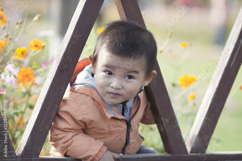 Happy Chinese baby boy playing in a park