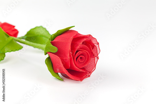 artificial red rose on white background