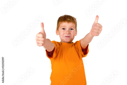 the little boy with red hair shows gesture "OK"