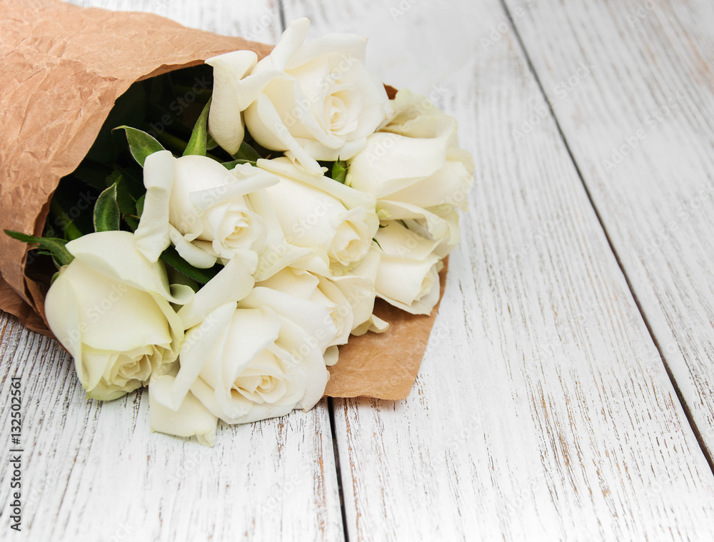 White roses on a wooden table White roses on a wooden table