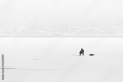 Winter fishing on the Volga river in Saratov. On the horizon is the city of Engels. Russia