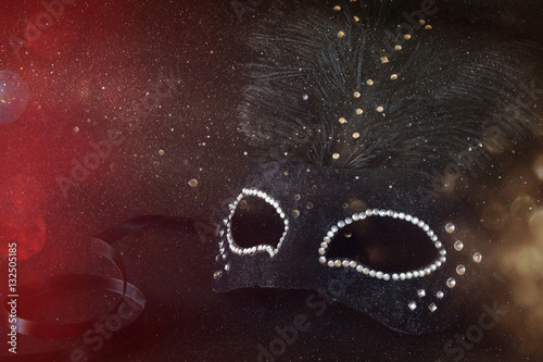 Image of black elegant venetian mask on glitter background. Shiny overlay
