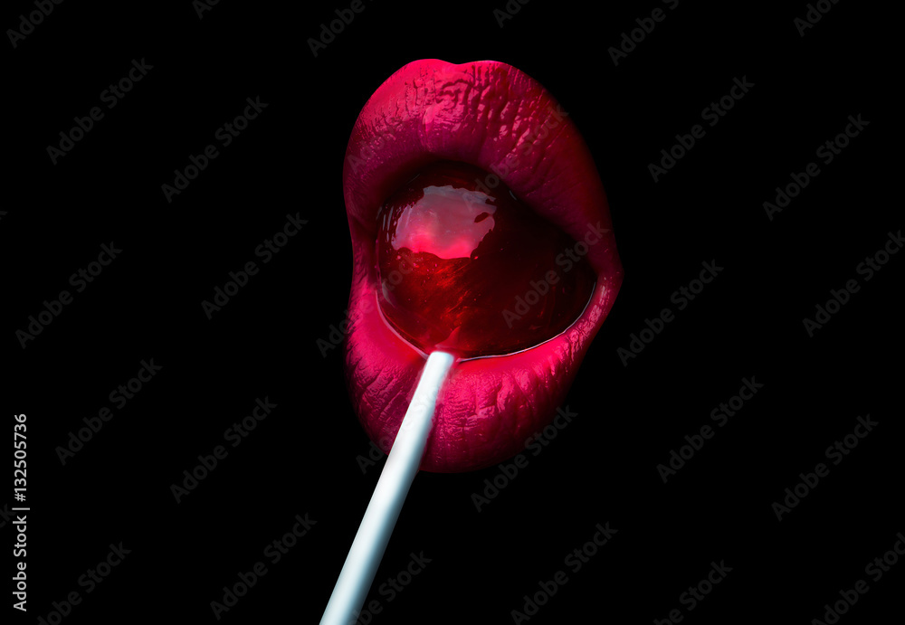 Red lips with a lollipop isolated on a black background Stock Photo
