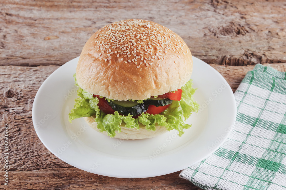 Tasty fresh Burger on the white plate Tasty fresh Burger on the white plate