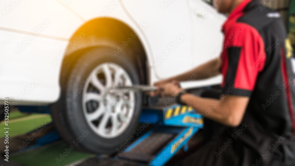 Fototapeta premium blurbackground of technician installing the wheels.