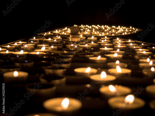 Tea candles on a black background.