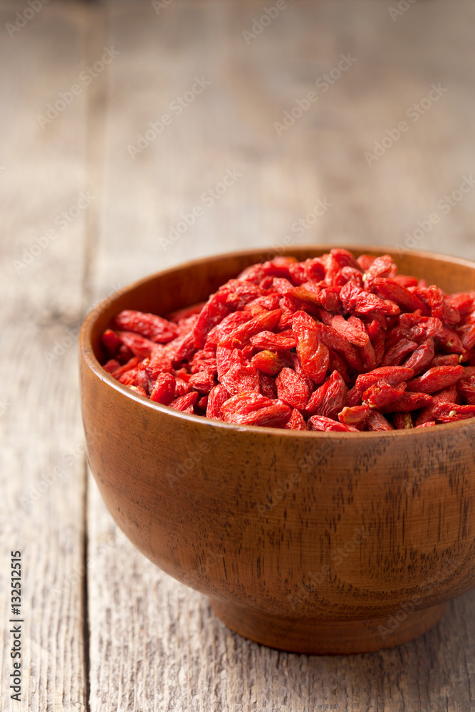 Goji berries in a wooden bowl Goji berries in a wooden bowl