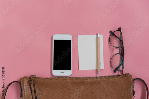 Top view of woman hipster travller stuff with phone,notepad,glas photo