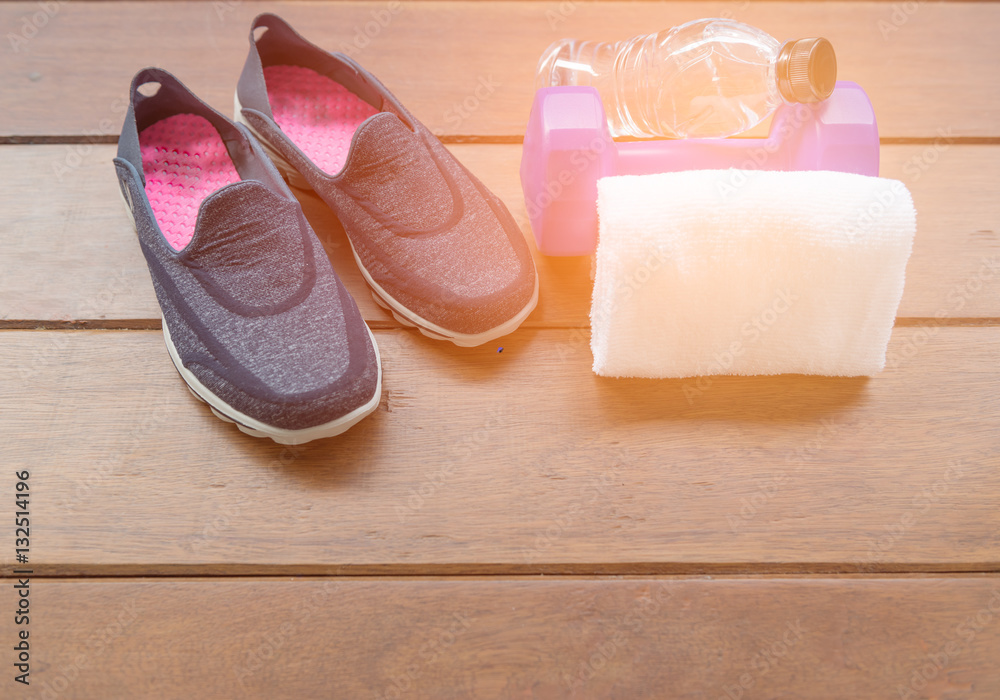 Top view of fitness equipment,shoes bottle and dumbell on wooden Top view of fitness equipment,shoes bottle and dumbell on wooden