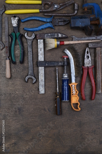 Set of old tools on wooden background, top view