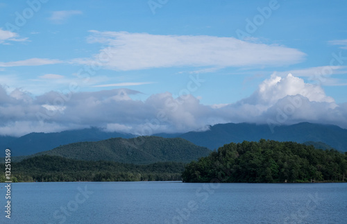 summer mountains green grass and blue sky landscape on river