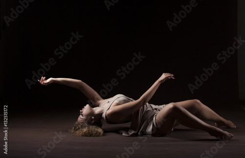 Young beautiful dancer in beige dress photo