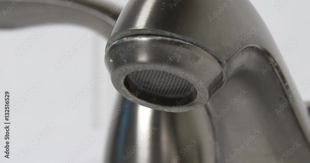 Extreme close up of a water faucet with a steady drip in 4K Extreme close up of a water faucet with a steady drip in 4K