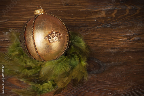 handmade golden chrostmas ball on wooden background photo