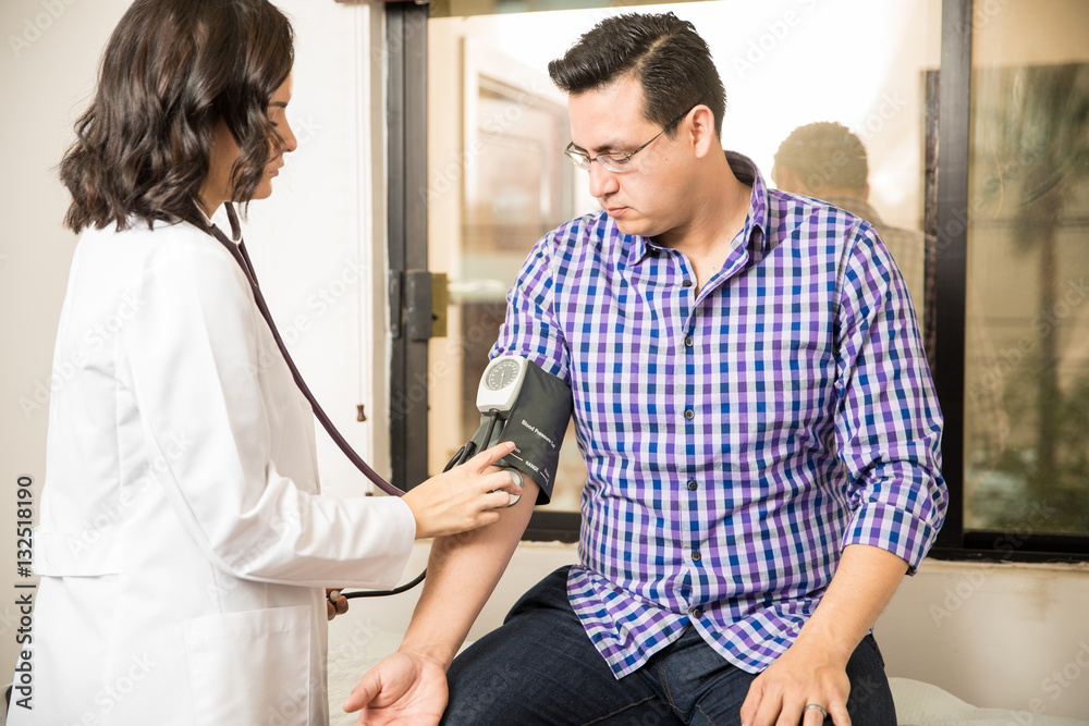 Doctor measuring blood pressure Doctor measuring blood pressure