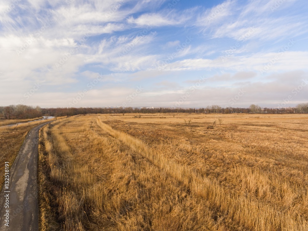 Fototapeta premium Country road in winter time. Aerial view.