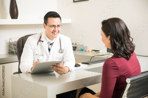 Friendly doctor talking to a patient