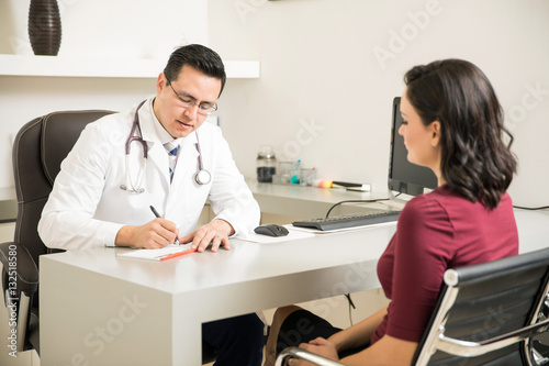 Doctor prescribing some medicine to patient