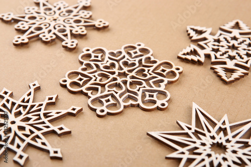 Laser cut wood snowflakes ornaments. Wooden snowflakes on carton.