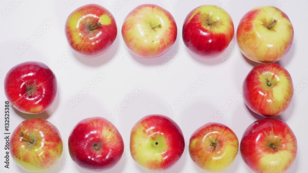 Ripe apples are arranged in shape of square on white background, fruits appear and disappear in different order. Stop motion. Close up, 4K Ultra HD. Ripe apples are arranged in shape of square on white background, fruits appear and disappear in different order. Stop motion. Close up, 4K Ultra HD.