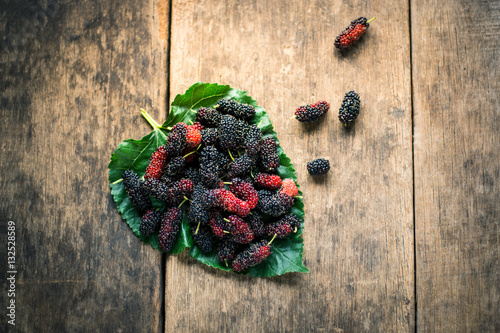 mulberry on leaf with wooden background