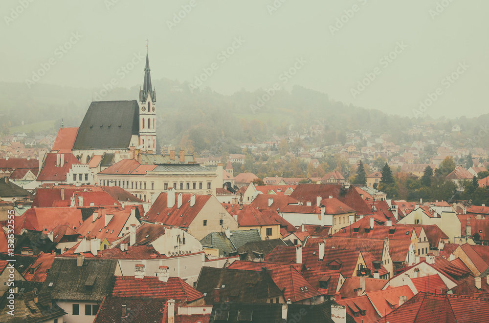 Cesky Krumlov - a famous czech historical beautiful town frome above, travel vintage hipster background with red roofs and chapel