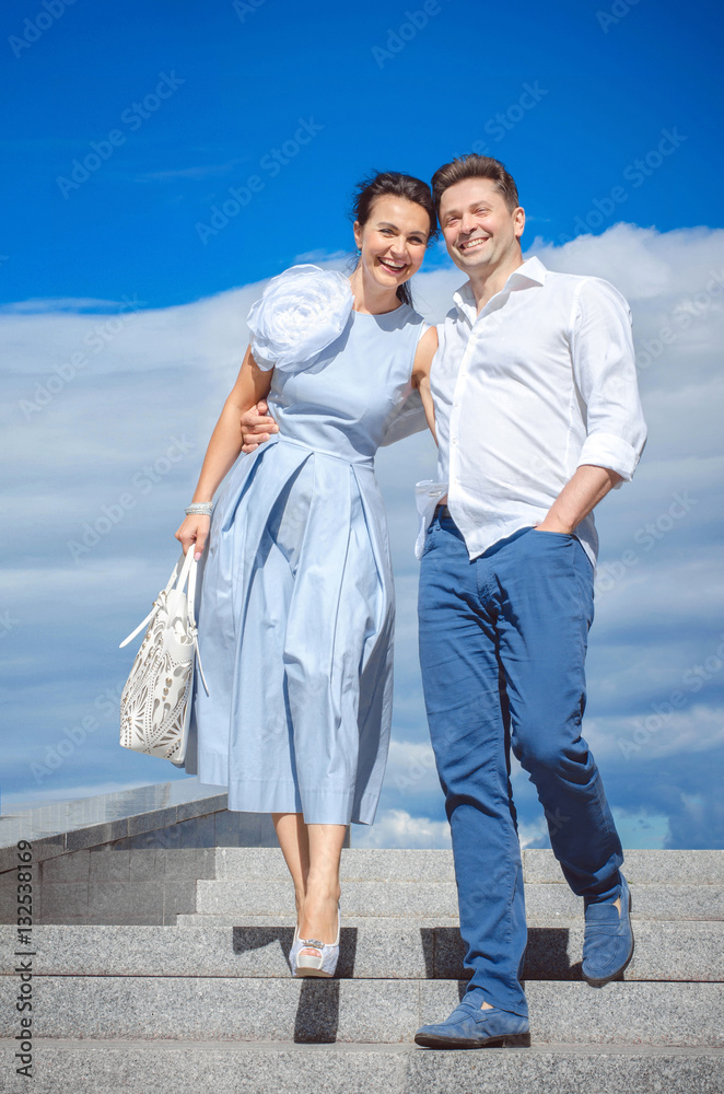 Beautiful couple in love on the background of the sky. Laughing man and woman. Beautiful couple in love on the background of the sky. Laughing man and woman.