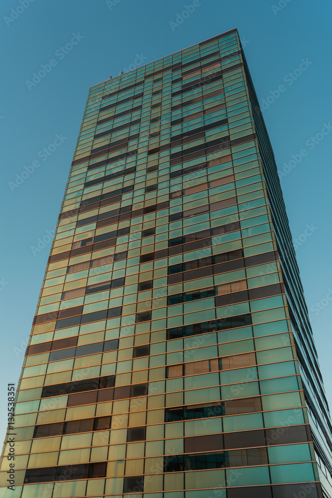 Brown and green colored glass windows on building Brown and green colored glass windows on building
