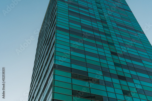 Green glass building detail view from low angle