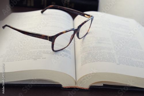 Reading glasses and a text book