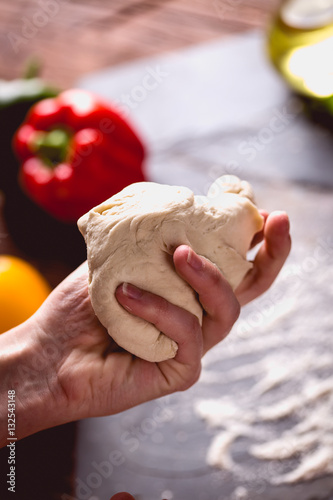 Young girl's hand knead the dough