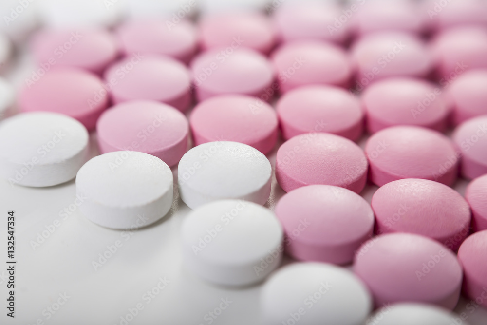 Close up of pink and white pills