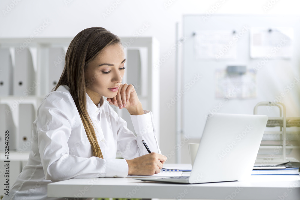 Concentrated businesswoman taking notes Concentrated businesswoman taking notes
