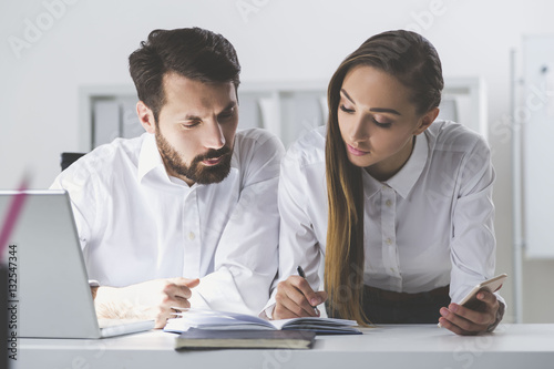 Man and woman looking at notes