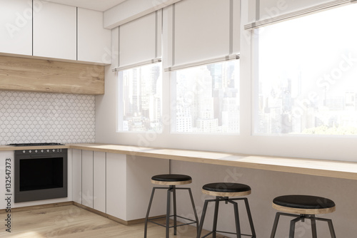 Side view of kitchen interior with white furniture