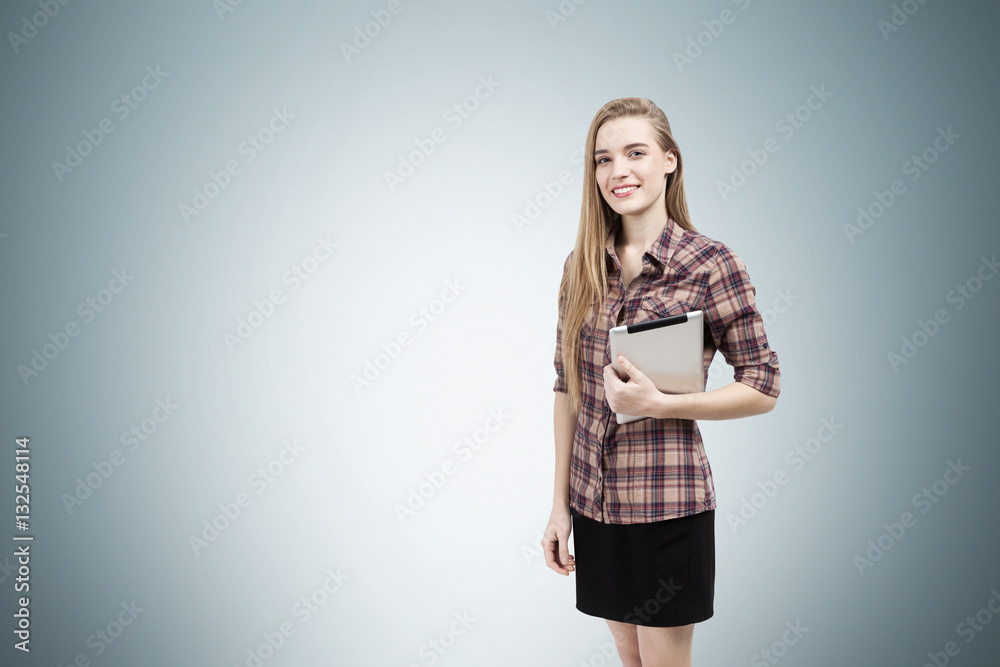 Girl in checkered shirt near a gray wall Girl in checkered shirt near a gray wall