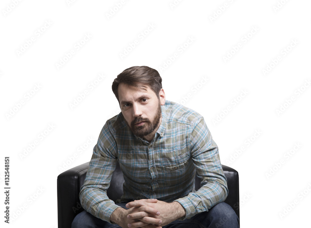 Bearded man sitting in an armchair Bearded man sitting in an armchair