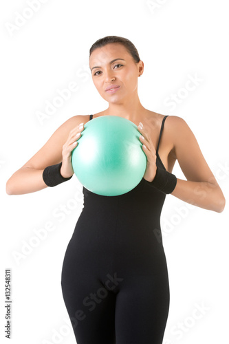 Fit Woman Standing Holding a Pilates Ball