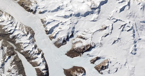 High-altitude overflight aerial of rock outcrops and bare valleys around Taylor Glacier, Antarctica. Clip loops and is reversible. Elements of this image furnished by USGS/NASA Landsat